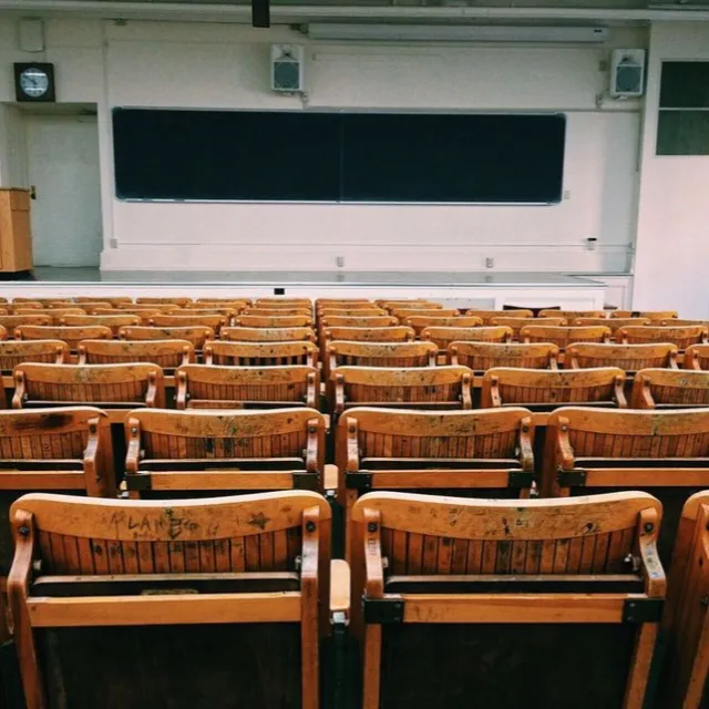 Classroom with rows of seats and a chalkboard